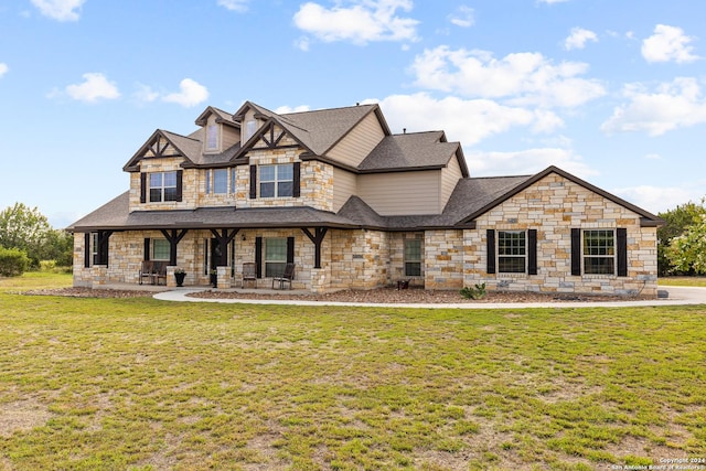 view of front facade featuring a front lawn, a porch, and a shingled roof