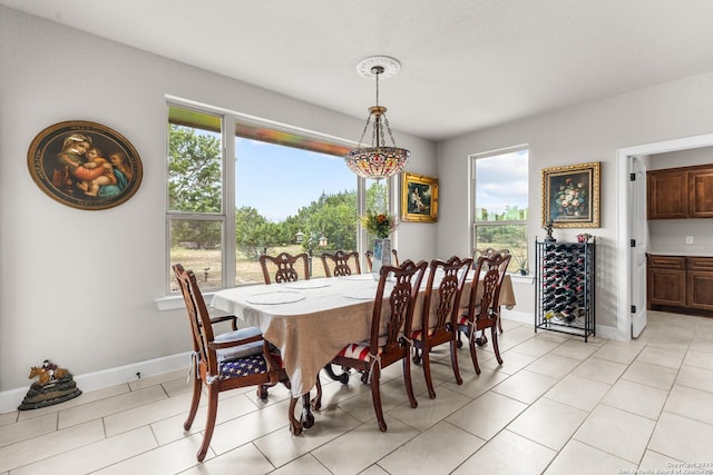 dining room with beverage cooler, baseboards, and light tile patterned floors