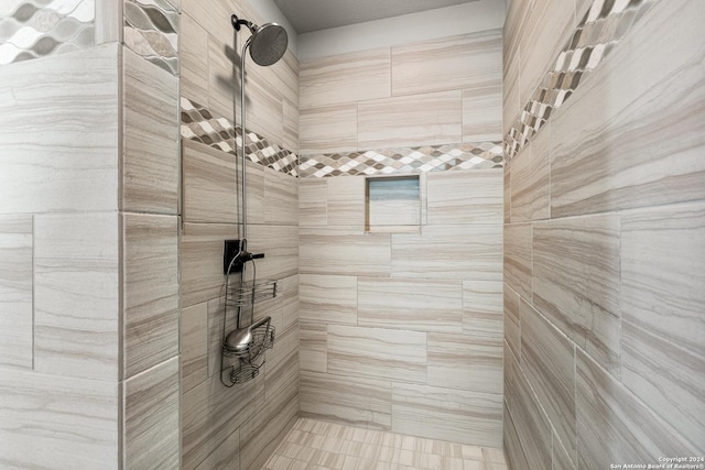 full bath featuring tiled shower