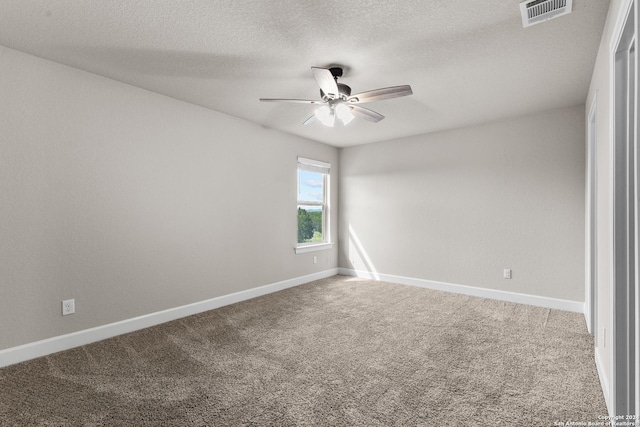 carpeted empty room with visible vents, ceiling fan, a textured ceiling, and baseboards