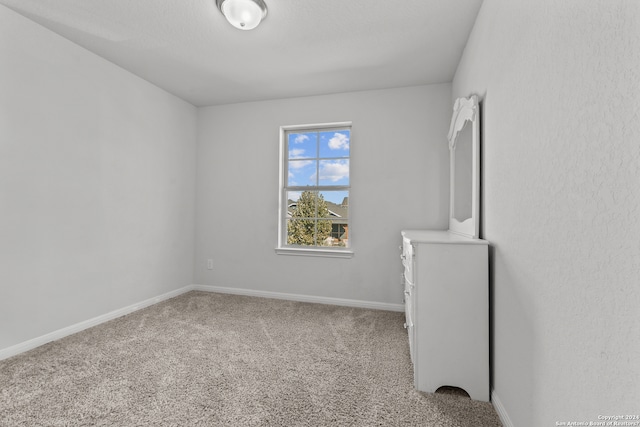 spare room with carpet flooring and baseboards