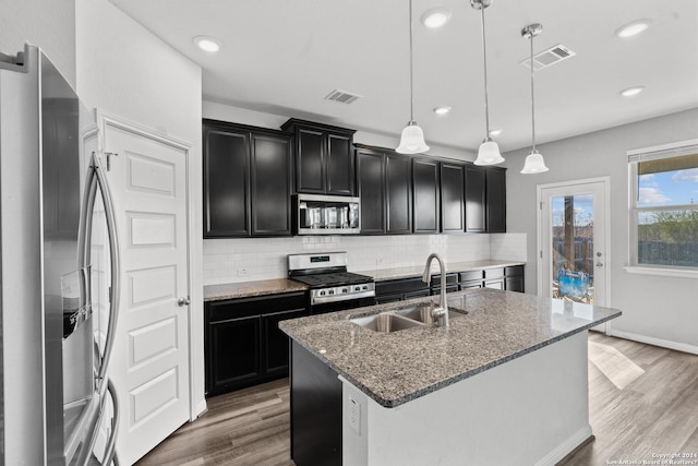 kitchen featuring a sink, visible vents, appliances with stainless steel finishes, and dark cabinets