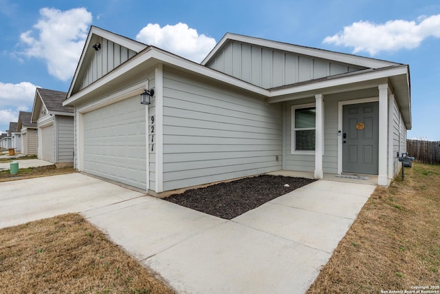 9211 Navarro Vis, Seguin, TX 78155 - single story home featuring driveway, board and batten siding, and an attached garage