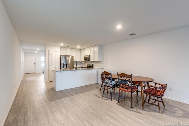 9211 Navarro Vis, Seguin, TX 78155 - dining area with recessed lighting, visible vents, light wood-style flooring, and baseboards