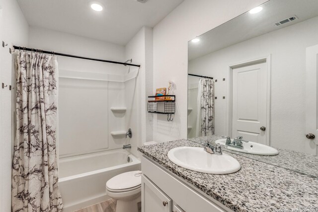 9211 Navarro Vis, Seguin, TX 78155 - bathroom featuring visible vents, toilet, shower / bath combo with shower curtain, vanity, and wood finished floors