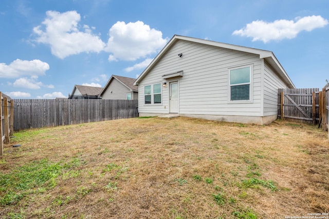 9211 Navarro Vis, Seguin, TX 78155 - rear view of house featuring a lawn and a fenced backyard
