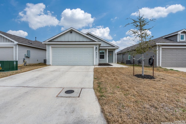 9211 Navarro Vis, Seguin, TX 78155 - ranch-style house with driveway, a garage, cooling unit, board and batten siding, and a front yard
