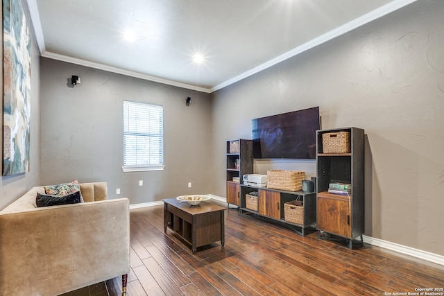 living area with baseboards, crown molding, and wood finished floors