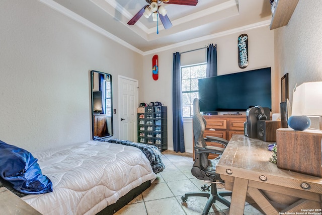 bedroom featuring ornamental molding, a tray ceiling, and a textured wall