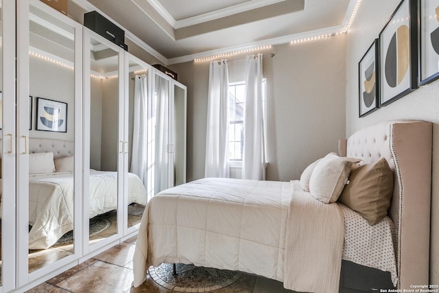 bedroom with a tray ceiling and ornamental molding