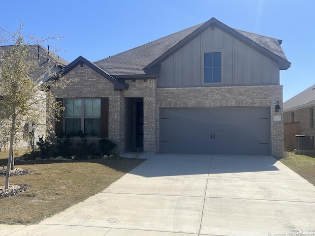 view of front of home with driveway, brick siding, and board and batten siding