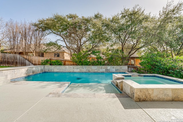 view of pool featuring an in ground hot tub, a patio, fence, and a fenced in pool