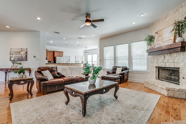 living room with recessed lighting, a fireplace, a ceiling fan, visible vents, and light wood-type flooring