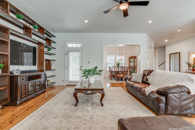 living room with light wood-style floors, a ceiling fan, and recessed lighting