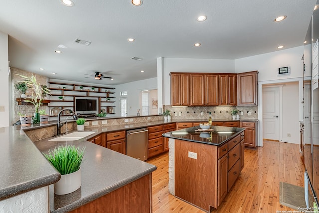 kitchen with stainless steel dishwasher, a spacious island, a sink, and brown cabinetry