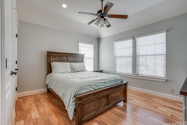 bedroom featuring light wood-type flooring, a ceiling fan, and baseboards