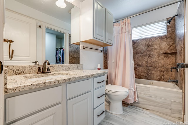 full bath featuring shower / bath combo, vanity, and toilet