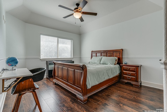 bedroom featuring ceiling fan, dark wood-type flooring, and baseboards