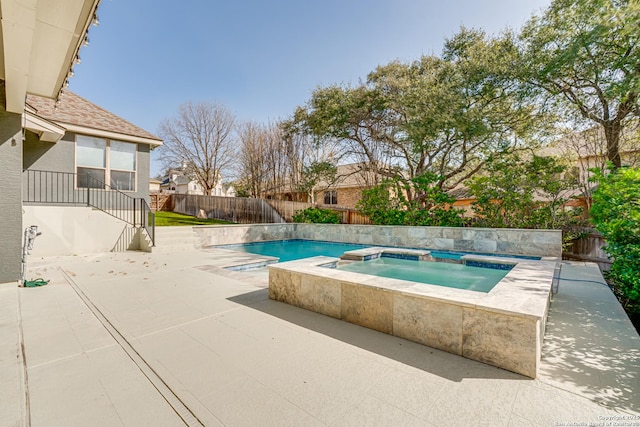 view of pool with a patio area, a fenced backyard, and an in ground hot tub