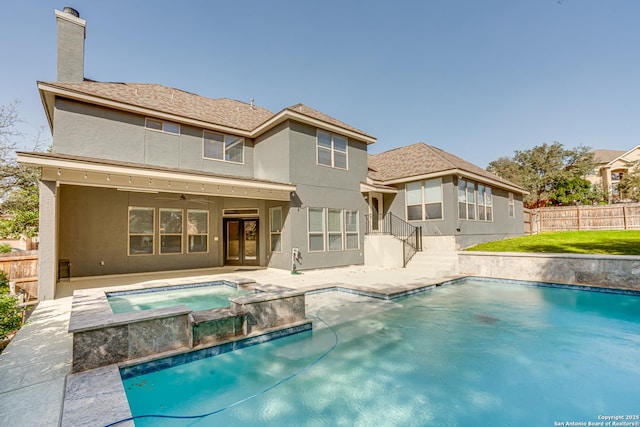 rear view of property featuring a fenced in pool, an in ground hot tub, a fenced backyard, and stucco siding