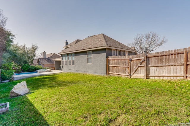 view of yard with a fenced in pool and fence