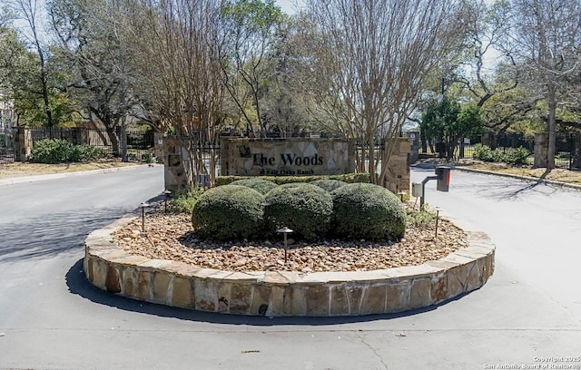 community sign featuring fence