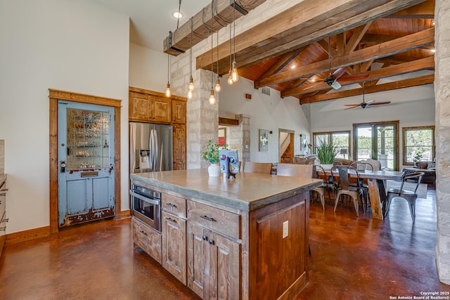 kitchen featuring a center island, brown cabinets, finished concrete flooring, stainless steel appliances, and high vaulted ceiling