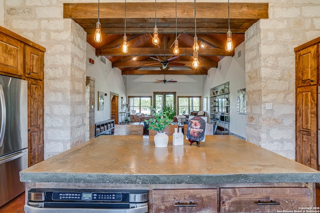 kitchen with beam ceiling, brown cabinetry, freestanding refrigerator, open floor plan, and high vaulted ceiling