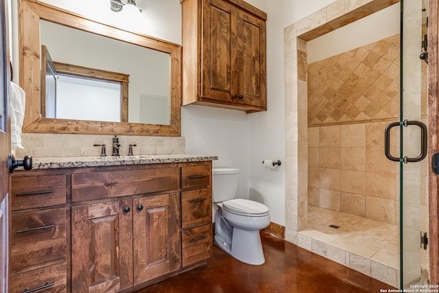 bathroom with vanity, backsplash, a shower stall, and toilet