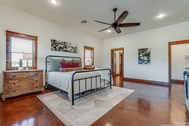 bedroom with finished concrete flooring, multiple windows, visible vents, and recessed lighting