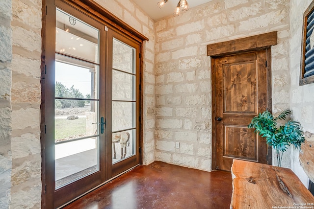 doorway to outside featuring french doors and finished concrete floors