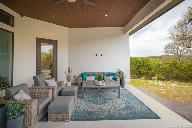 view of patio / terrace with ceiling fan and an outdoor living space