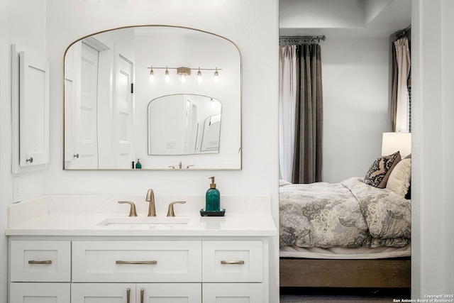 ensuite bathroom featuring connected bathroom and vanity