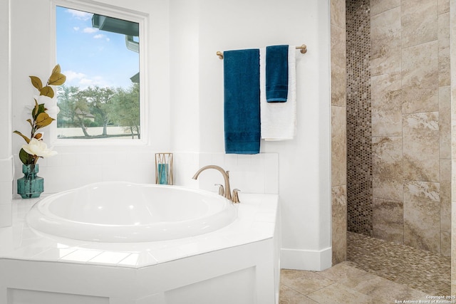 full bath featuring tiled shower, a bath, and tile patterned floors