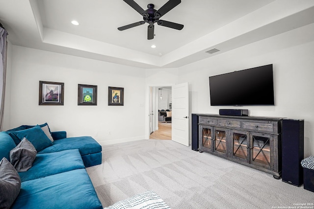 living area with recessed lighting, visible vents, baseboards, a tray ceiling, and carpet