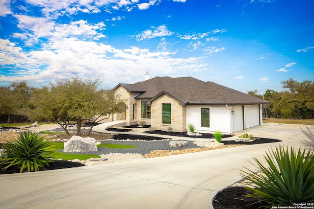 view of front of house featuring a garage, stone siding, a shingled roof, and concrete driveway