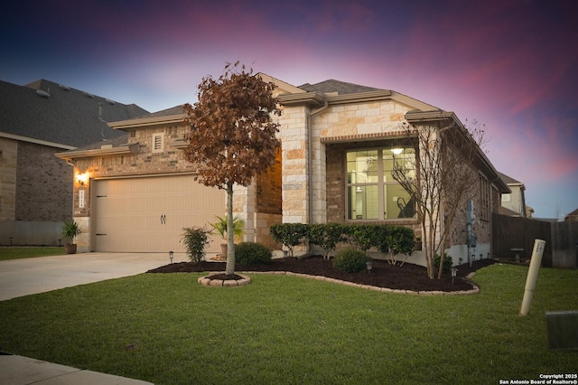 view of front of property featuring a garage, stone siding, a yard, and concrete driveway