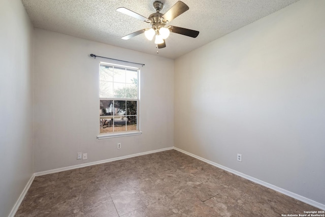 empty room featuring a ceiling fan, a textured ceiling, and baseboards