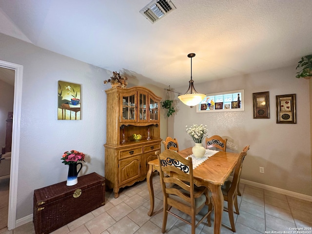 dining room with visible vents, baseboards, and light tile patterned floors