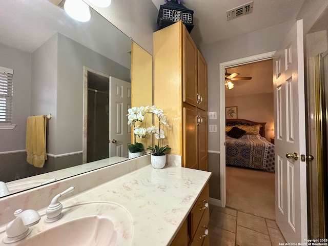 bathroom with vanity, visible vents, a shower stall, tile patterned floors, and ensuite bath