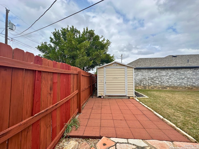 view of patio featuring an outbuilding, a fenced backyard, and a shed