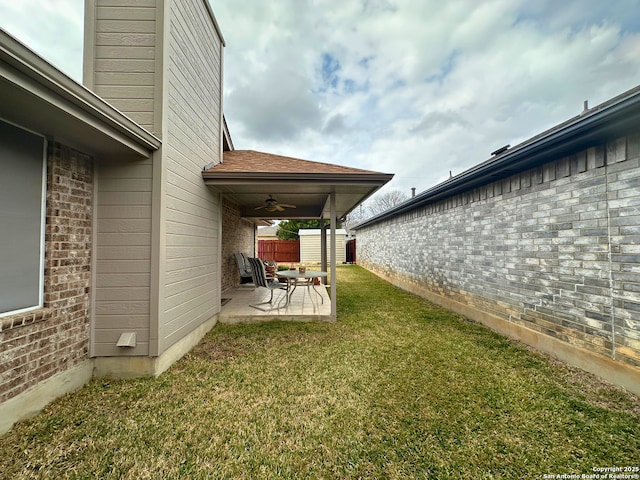 view of yard featuring ceiling fan, a patio, and fence