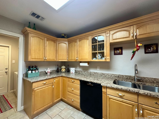 kitchen with visible vents, dishwasher, glass insert cabinets, light stone counters, and a sink