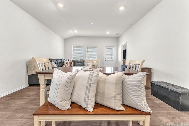 dining room featuring lofted ceiling, visible vents, wood finished floors, and recessed lighting