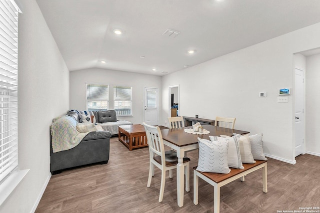 dining room with vaulted ceiling, baseboards, wood finished floors, and recessed lighting