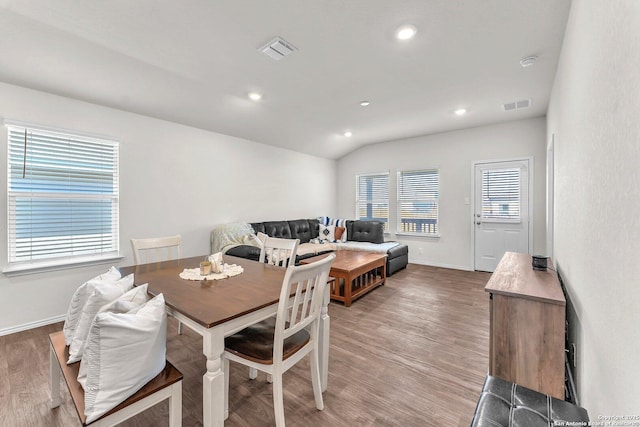 dining area featuring recessed lighting, visible vents, vaulted ceiling, and light wood-style flooring