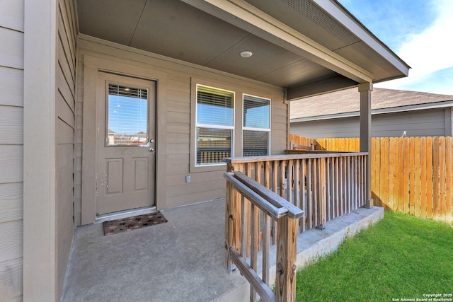 doorway to property featuring fence