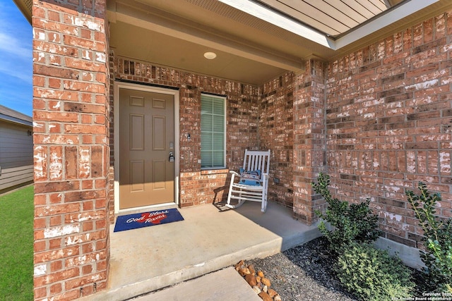 entrance to property with brick siding