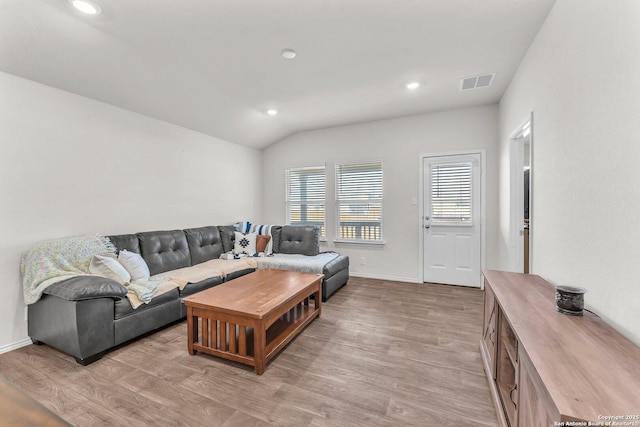 living area with recessed lighting, visible vents, baseboards, vaulted ceiling, and light wood-type flooring