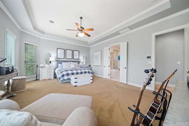 carpeted bedroom with baseboards, a tray ceiling, visible vents, and crown molding